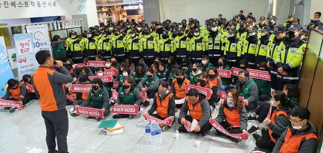 ▲ 도로공사 본사 농성장 안에서 경찰 앞에 앉아 있는 수납원들. ⓒ민주일반연맹